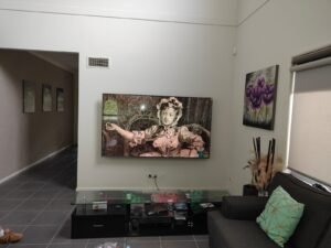 Mounted flat-screen TV in a contemporary living room setting.